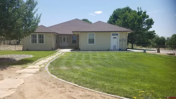 a view of a house with a garden and yard
