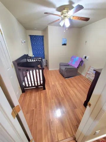 a bedroom with a bed and a ceiling fan