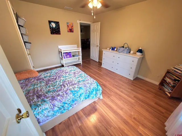 a bedroom with a bed and a dresser