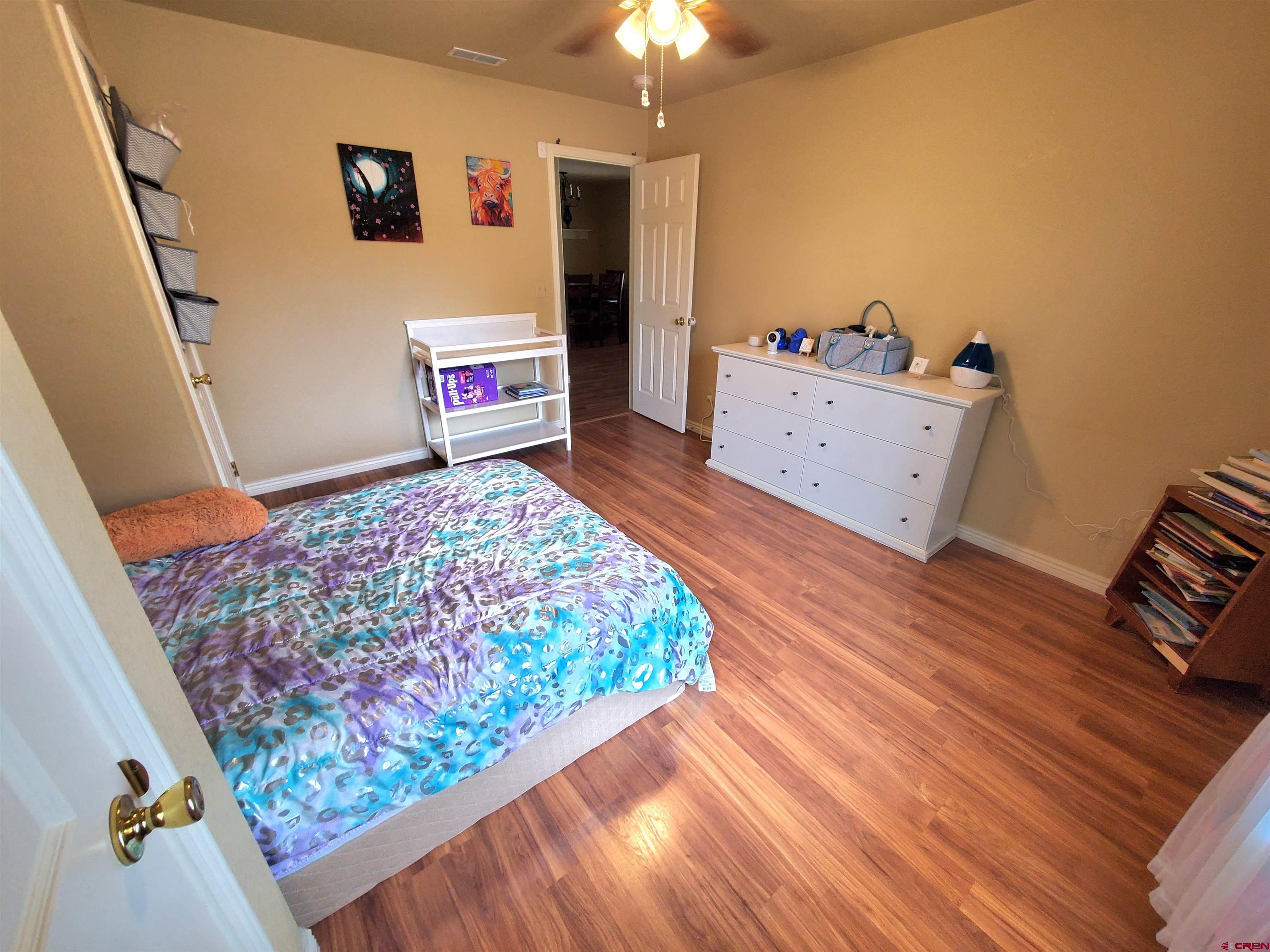 7095 Buena Vista Road Delta, CO 81416 - Photo 17 of 33 a bedroom with a bed and a dresser