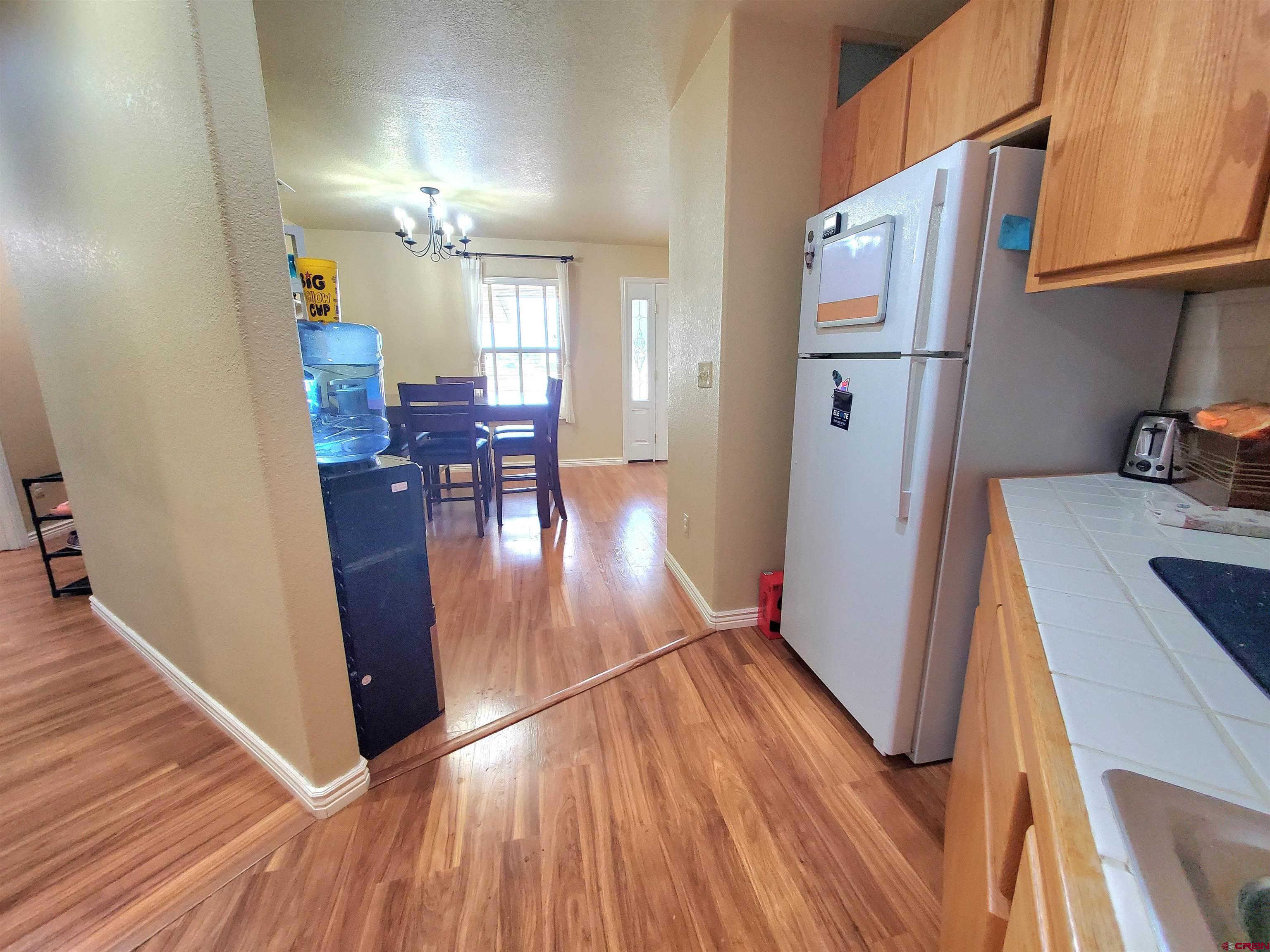 7095 Buena Vista Road Delta, CO 81416 - Photo 18 of 33 a living room with hard wood floors and a kitchen