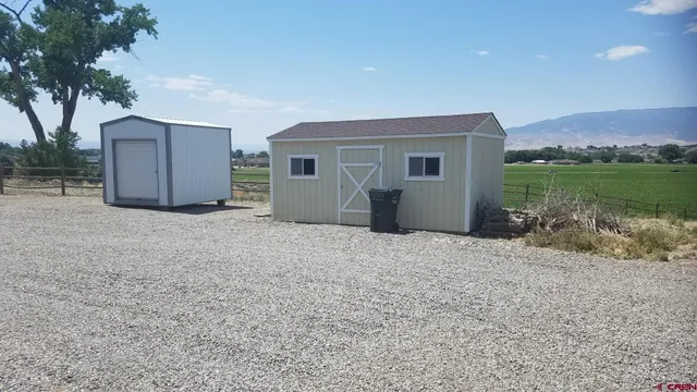 a view of a house with a yard and garage