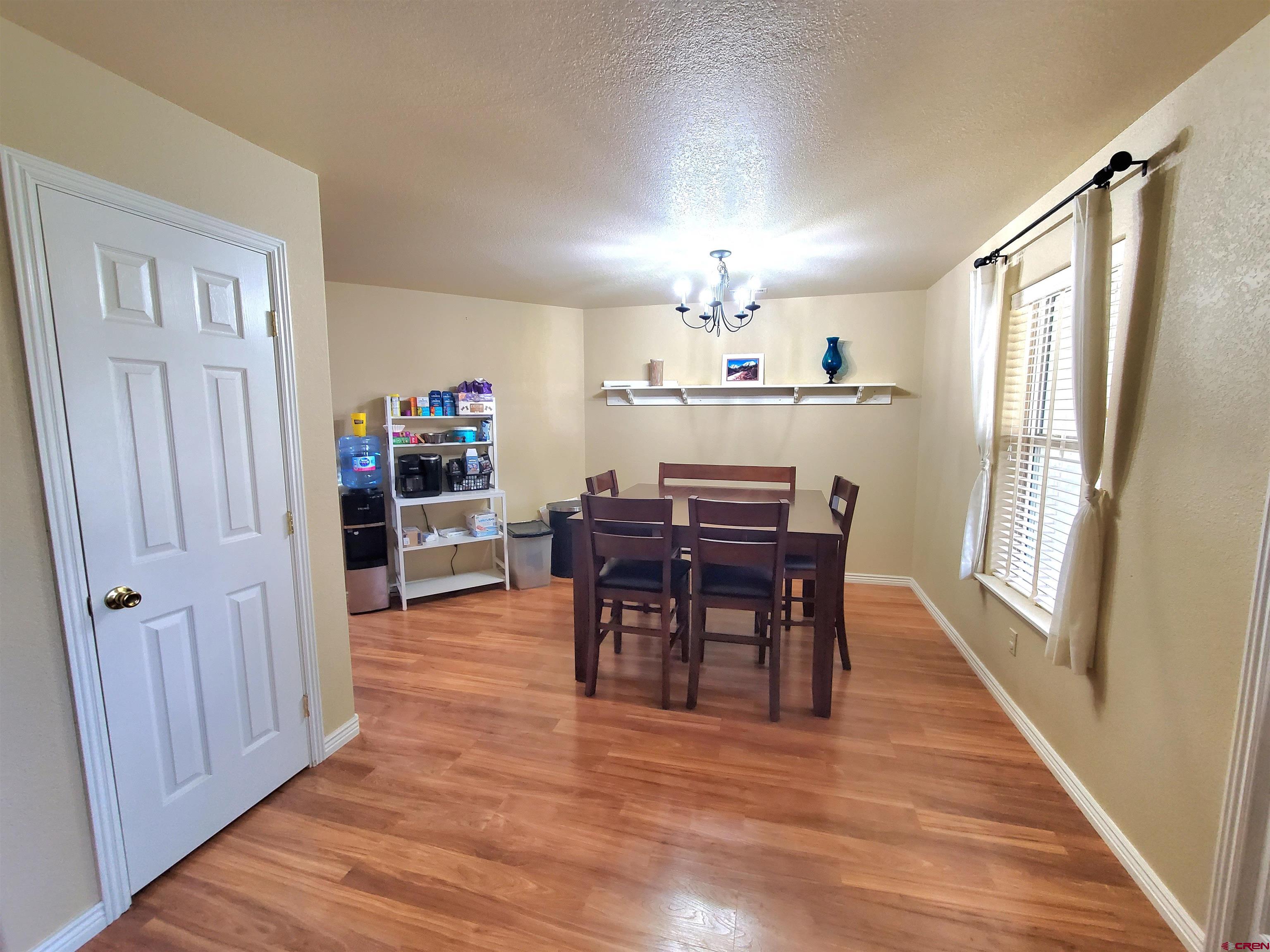 7095 Buena Vista Road Delta, CO 81416 - Photo 5 of 33 a view of a dining room with furniture window and wooden floor