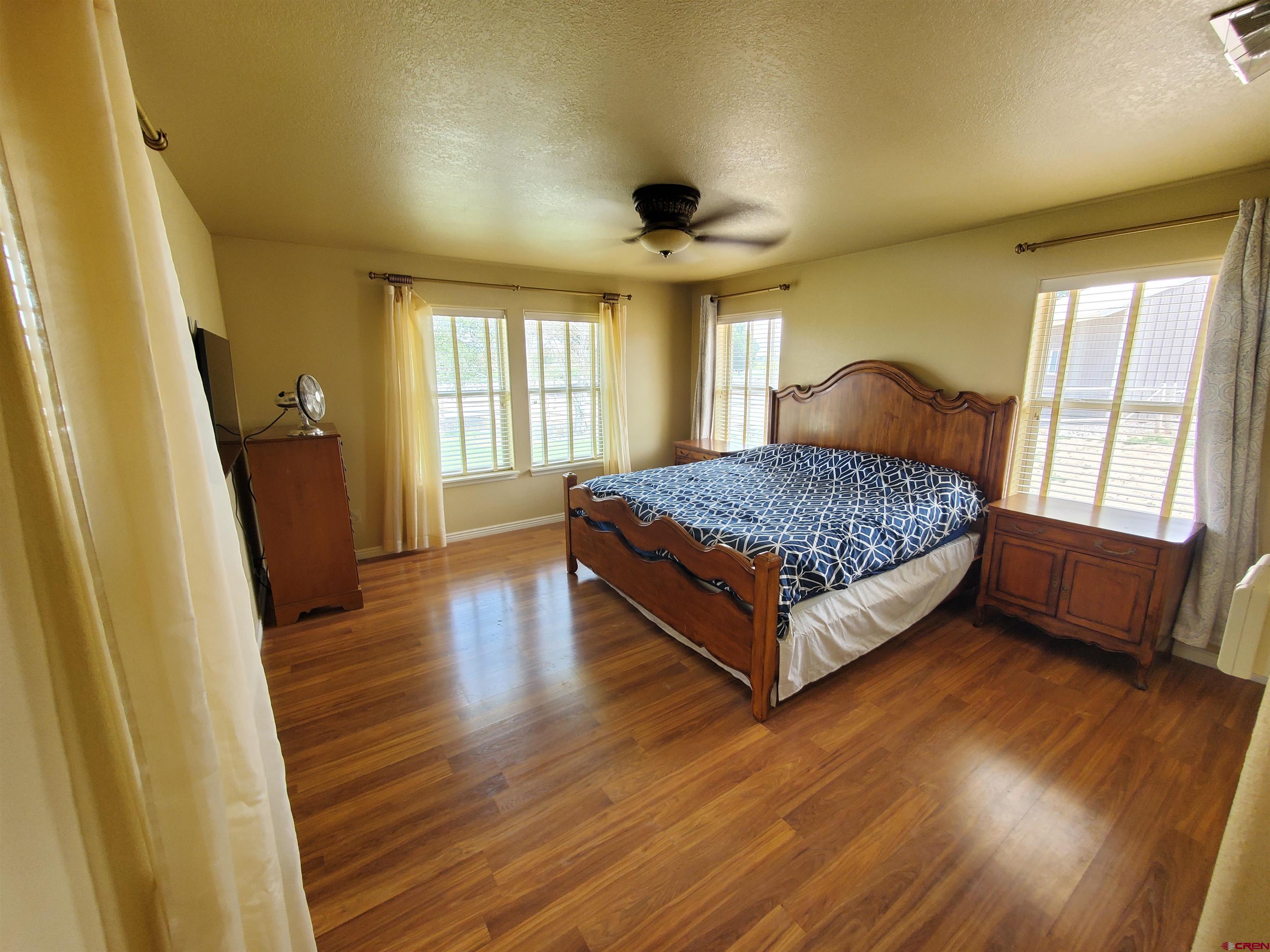 7095 Buena Vista Road Delta, CO 81416 - Photo 7 of 33 a spacious bedroom with a bed and wooden floor