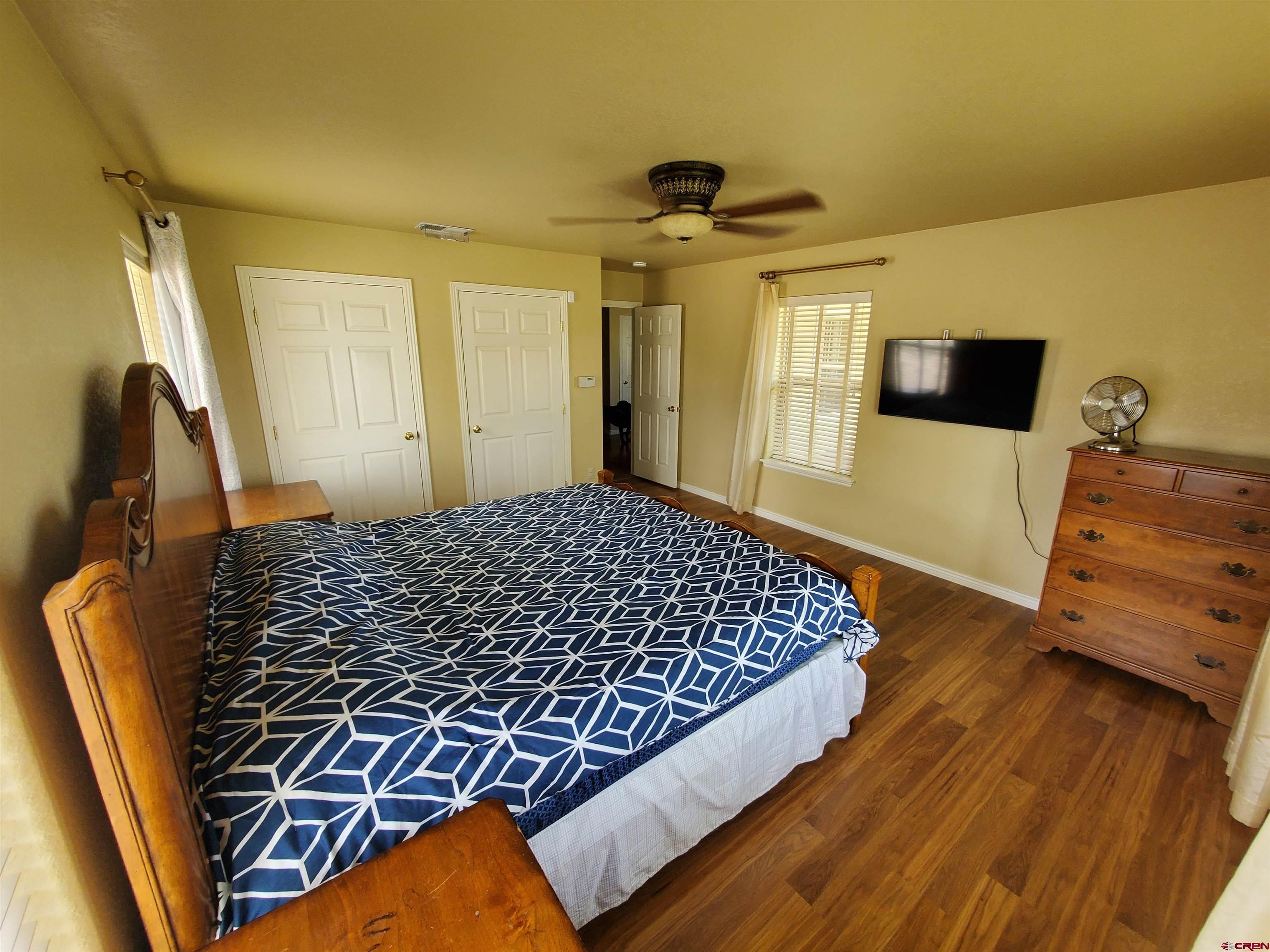 7095 Buena Vista Road Delta, CO 81416 - Photo 9 of 33 a bedroom with a bed and wooden floor