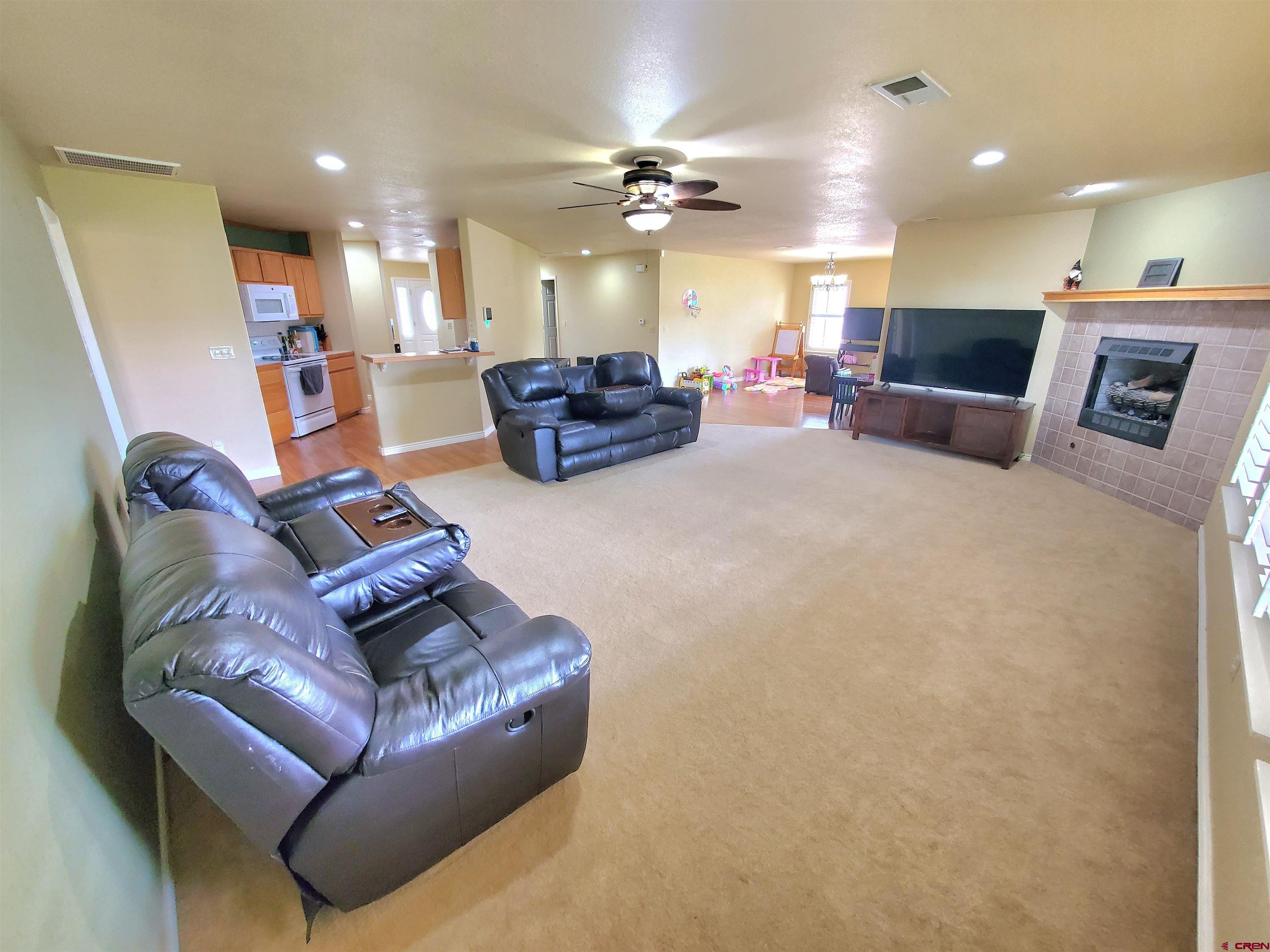 7095 Buena Vista Road Delta, CO 81416 - Photo 10 of 33 a living room with furniture kitchen view and a chandelier