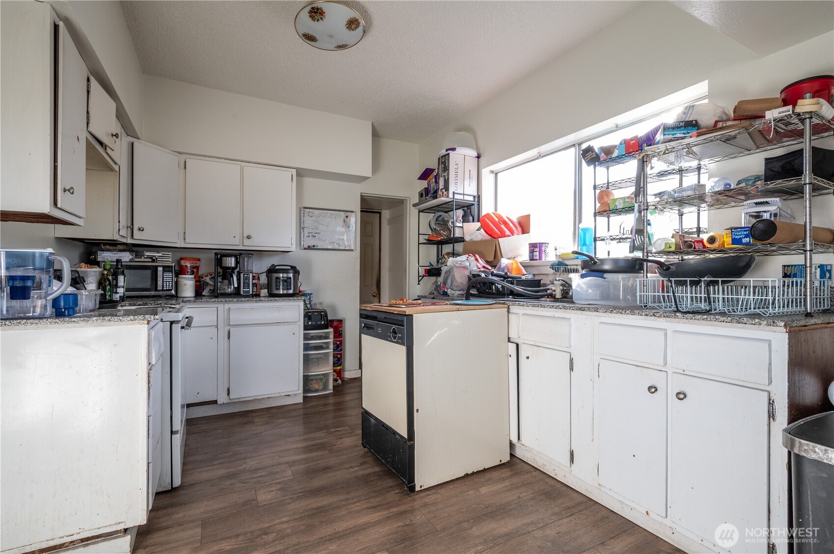 300 West 3rd Street Aberdeen, WA 98520 - Photo 17 of 28 a kitchen with white cabinets and window