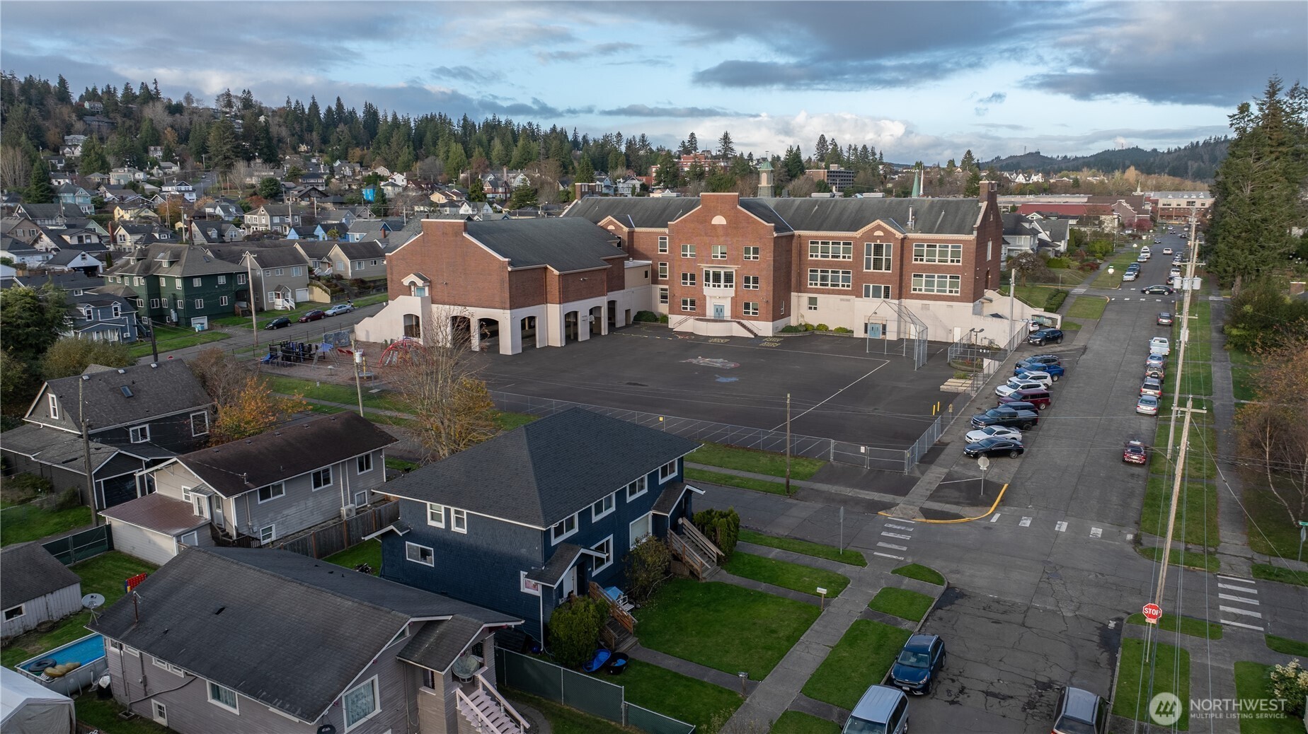 300 West 3rd Street Aberdeen, WA 98520 - Photo 23 of 28 an aerial view of a house with a garden and lake view