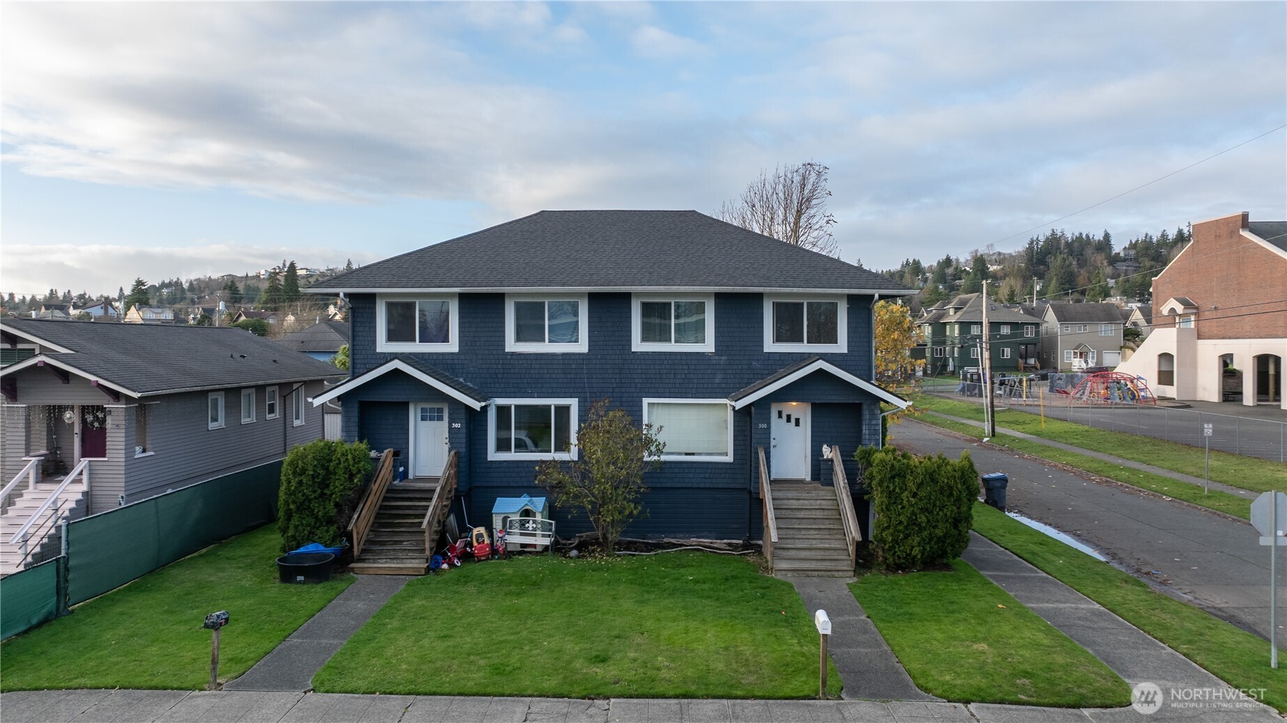 300 West 3rd Street Aberdeen, WA 98520 - Photo 3 of 28 a front view of a house with garden