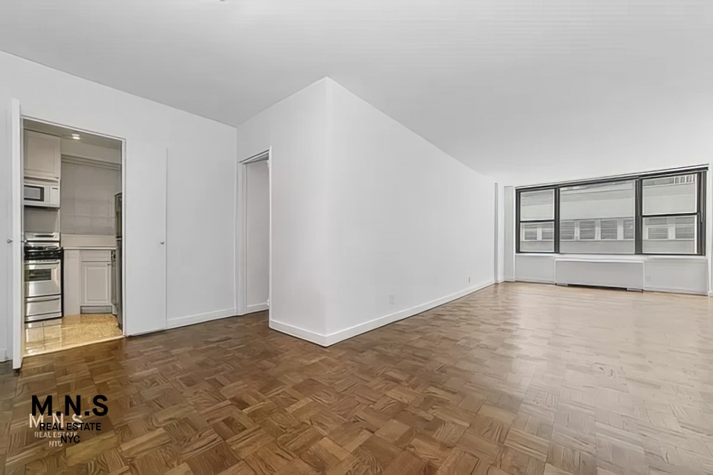 65 West 55th Street, Unit 10P Manhattan, NY 10019 - Photo 11 of 16 a view of an empty room with a window