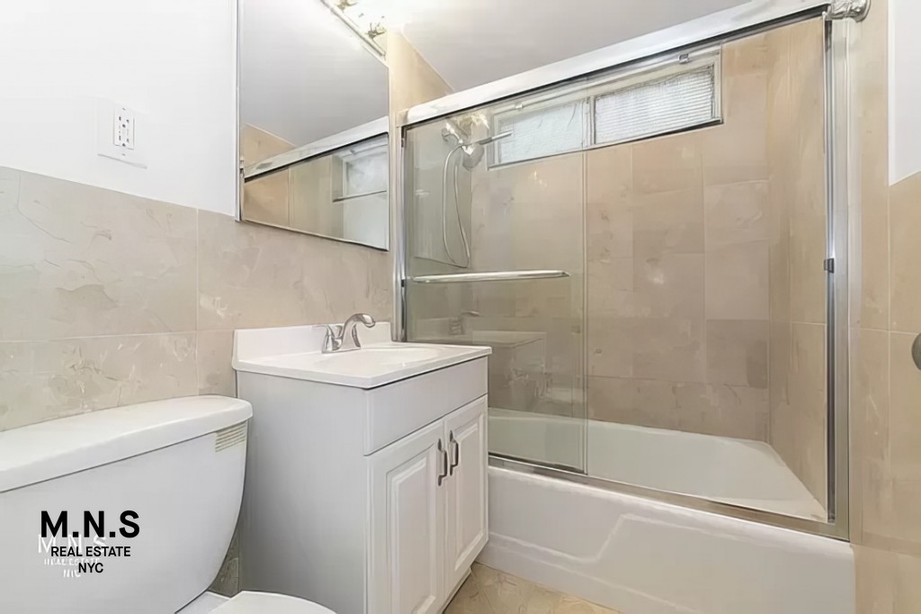 65 West 55th Street, Unit 10P Manhattan, NY 10019 - Photo 12 of 16 a bathroom with a sink a toilet and a bathtub