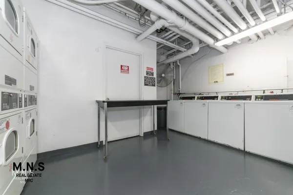 a view of a storage & utility room with cabinets