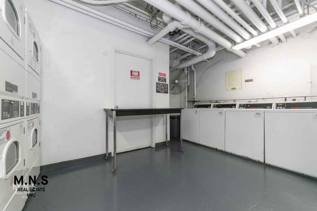 65 West 55th Street, Unit 10P Manhattan, NY 10019 - Photo 13 of 16 a view of a storage & utility room with cabinets