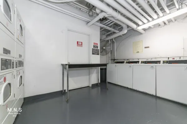 a view of a storage & utility room with cabinets