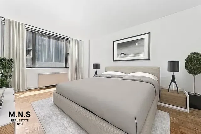 a bedroom with a bed and a painting on the wall