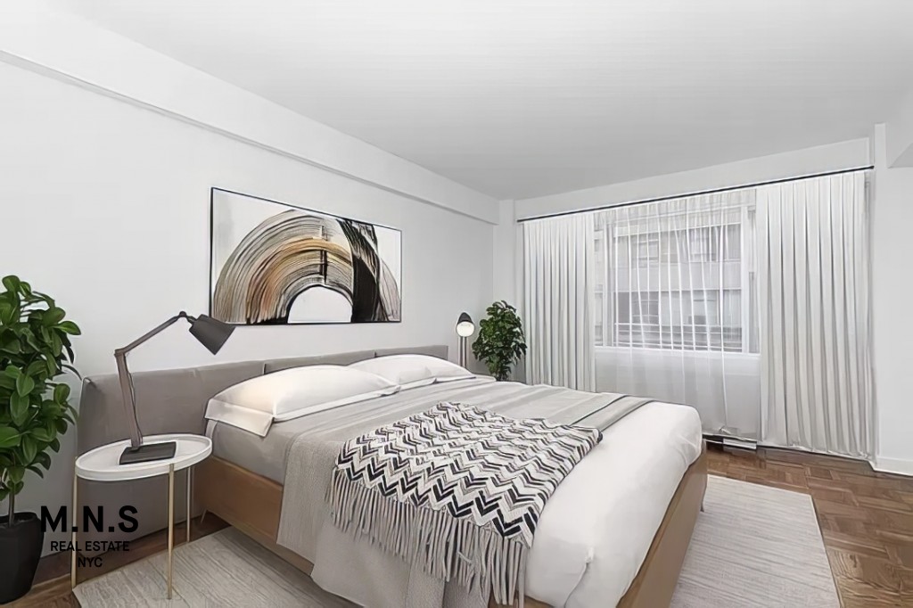 65 West 55th Street, Unit 10P Manhattan, NY 10019 - Photo 7 of 16 a bedroom with a bed and a painting on the wall