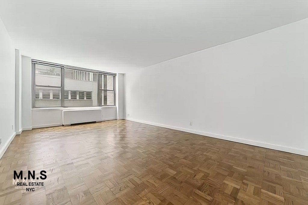 65 West 55th Street, Unit 10P Manhattan, NY 10019 - Photo 8 of 16 a view of an empty room with a window