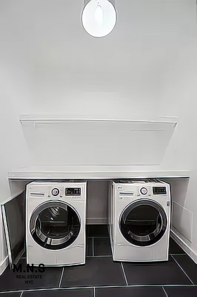 65 West 55th Street, Unit 10P Manhattan, NY 10019 - Photo 9 of 16 a utility room with dryer and washer