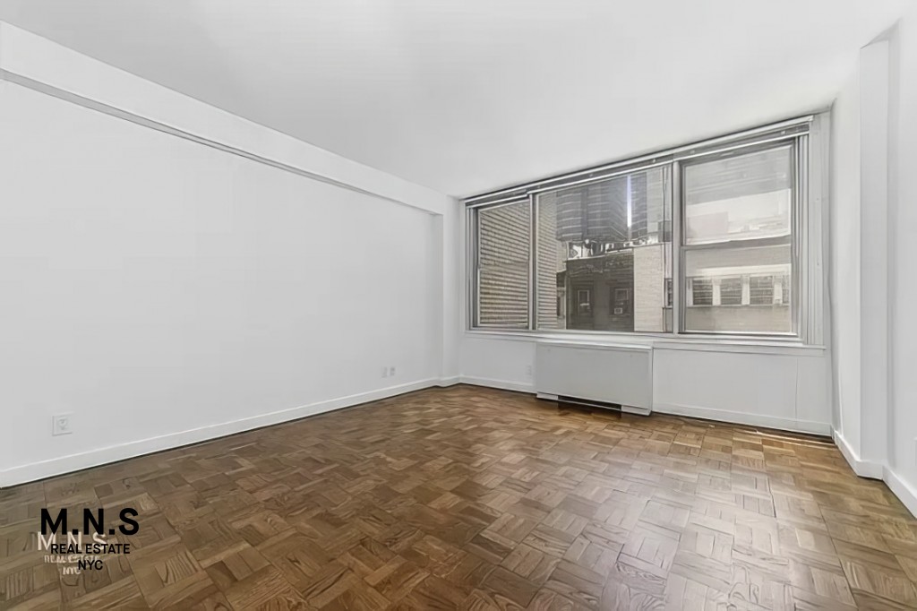 65 West 55th Street, Unit 10P Manhattan, NY 10019 - Photo 10 of 16 a view of an empty room with a window