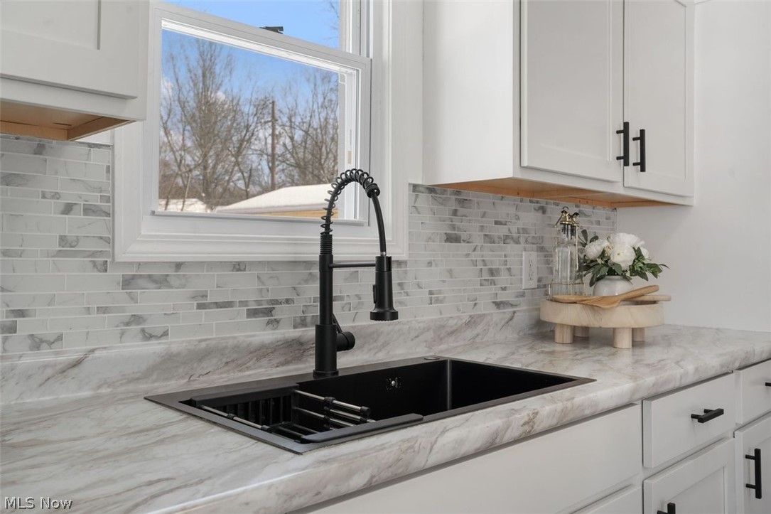 2401 Greenvale Road Cleveland, OH 44121 - Photo 11 of 25 Kitchen view of white cabinetry and light stone countertops