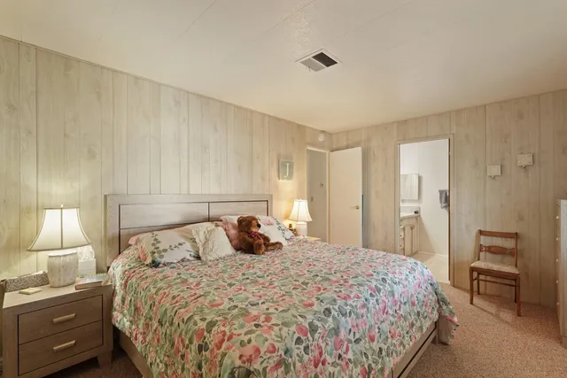 a bedroom with a bed and a lamp