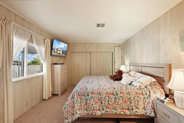 a bedroom with a bed and a cabinets