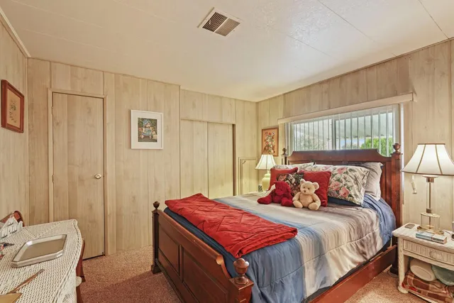 a bedroom with a bed and a chair