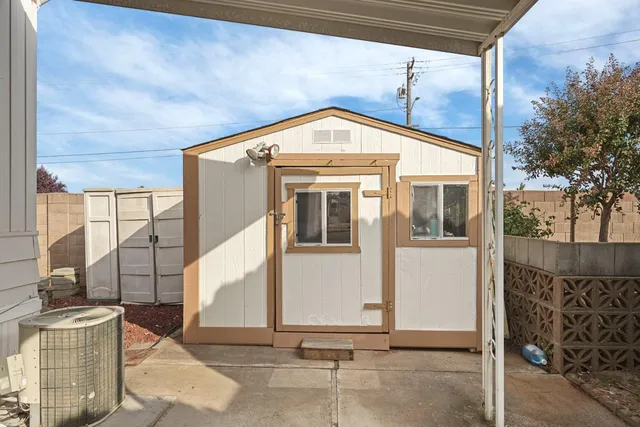 a view of a patio with table and chairs