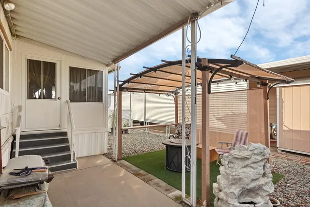 a view of a porch with furniture and garden