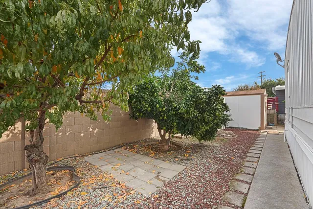 a view of a backyard with furniture and a grill