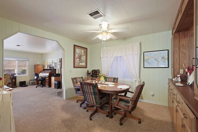 a view of a dining room with furniture and chandelier
