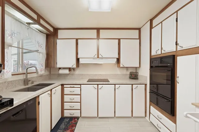 a kitchen with white cabinets and a sink