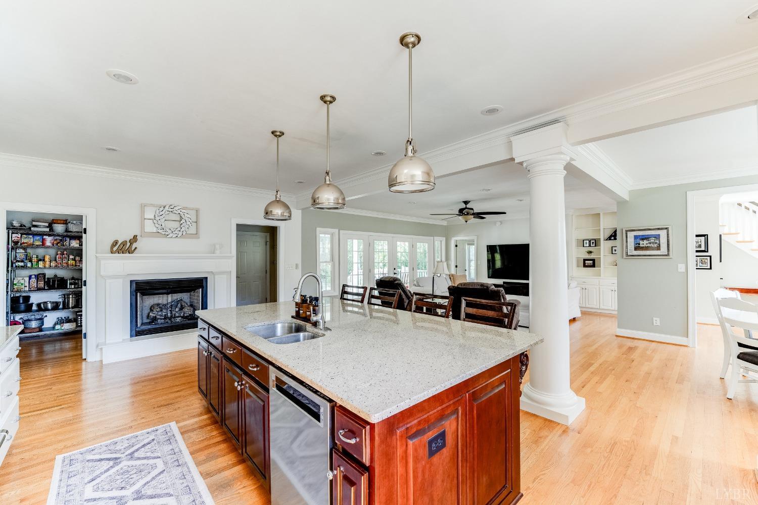 212 Barringer Drive Rustburg, VA 24588 - Photo 16 of 63 a kitchen with a stove a refrigerator a oven and a fireplace with wooden floor