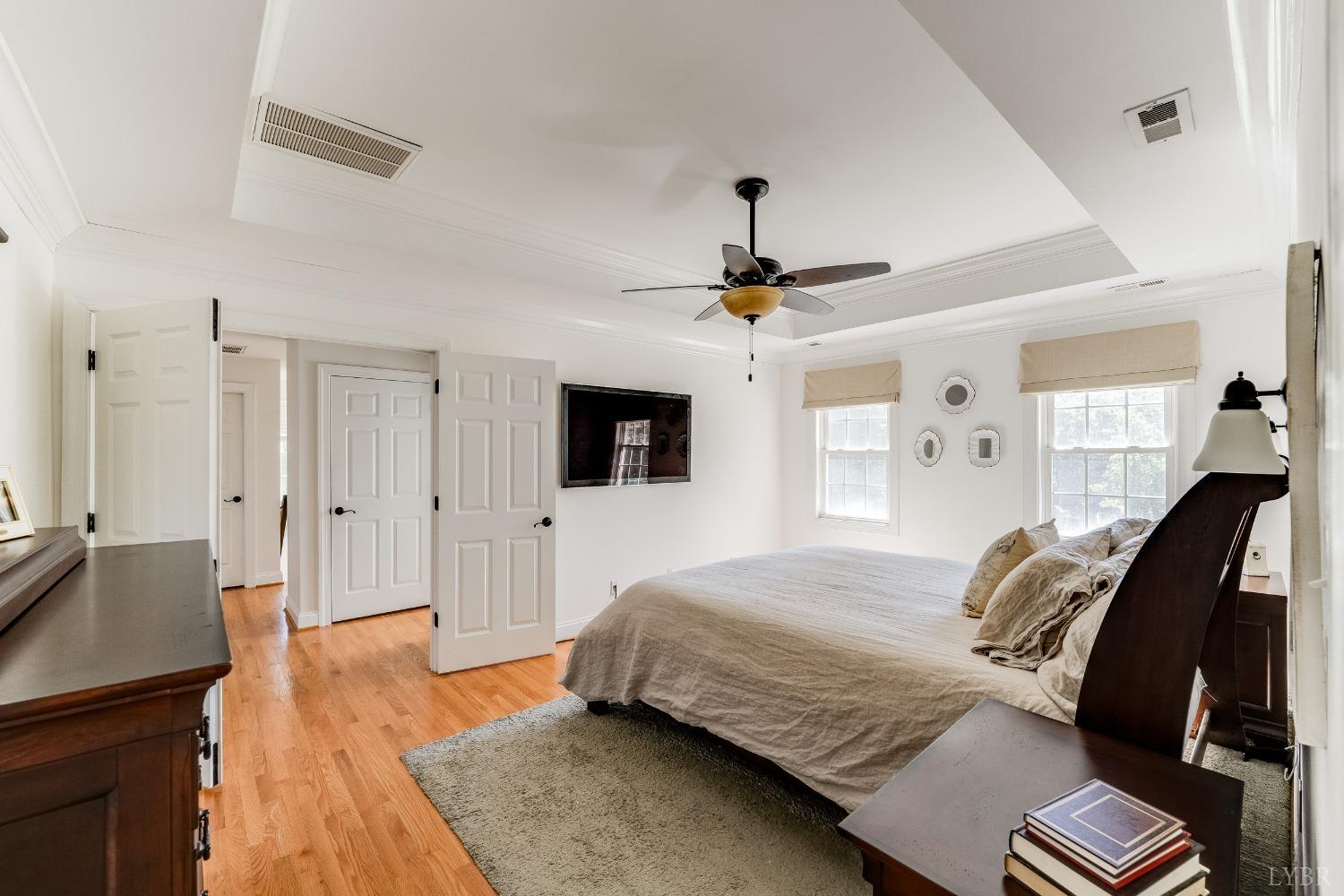 212 Barringer Drive Rustburg, VA 24588 - Photo 30 of 63 a bedroom with a bed and a chandelier