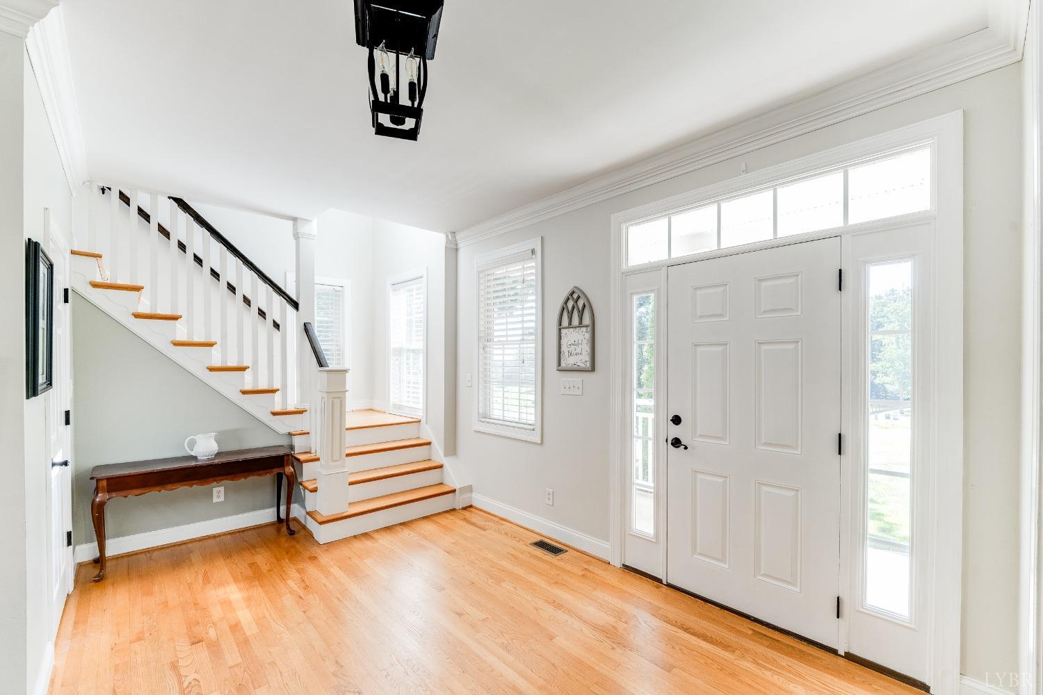 212 Barringer Drive Rustburg, VA 24588 - Photo 3 of 63 a view of entryway with wooden floor and stairs