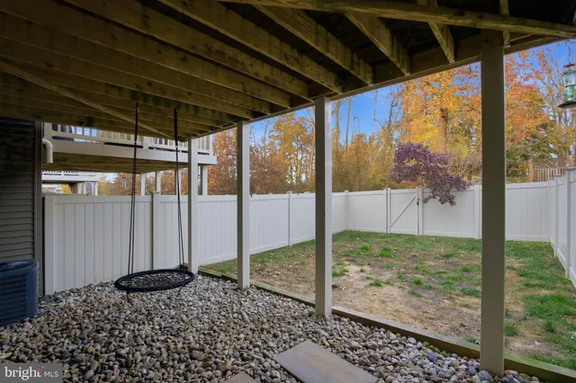 a view of a house with a window and wooden fence