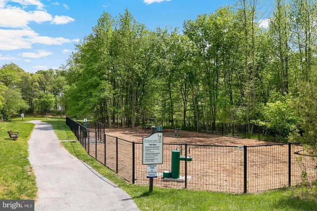 a view of a lake with a bench and trees