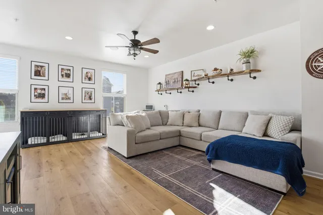 a living room with furniture a ceiling fan and a rug