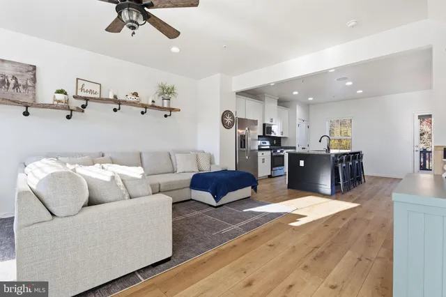 a living room with furniture and kitchen view