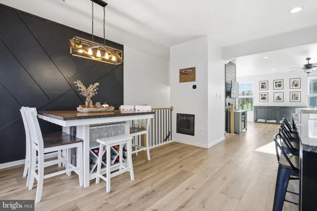 a view of a dining room with furniture wooden floor and a chandelier