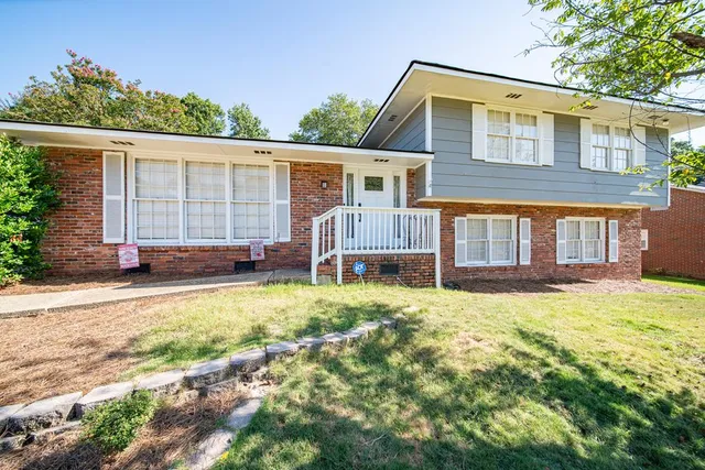 a backyard of a house with yard and outdoor seating