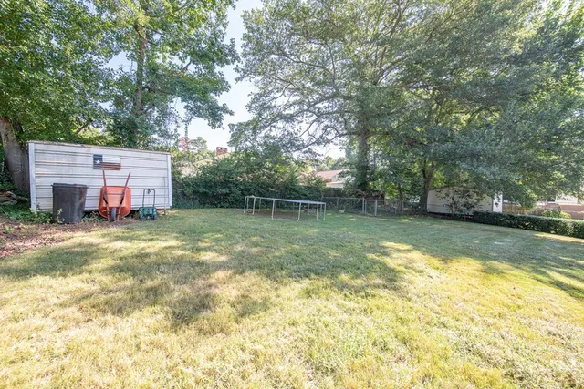 a view of a backyard with swimming pool