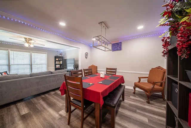 a kitchen with granite countertop kitchen island stainless steel appliances a sink stove and refrigerator