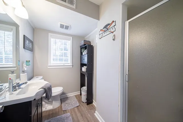 a bathroom with a sink toilet and shower