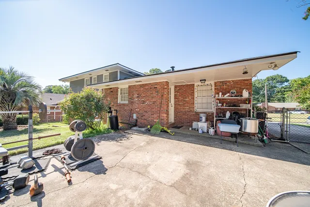 a front view of a house with garden and sitting area