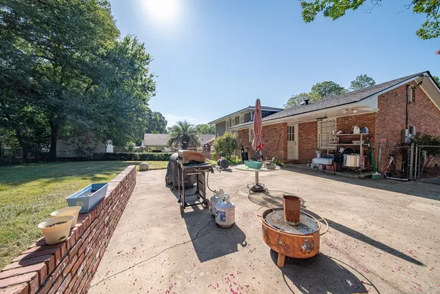 a view of a patio with chairs and a table