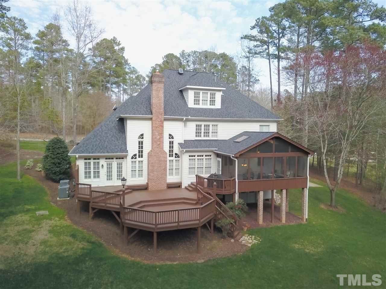 Archideck custom screened-in porch and multi-tier deck overlook the private back yard.