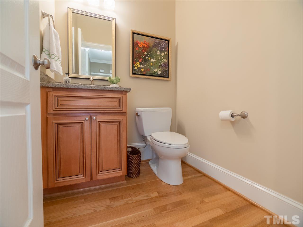 4016 White Chapel Way Raleigh, NC 27615 - Photo 11 of 30 Half bath has been updated with a comfort height cabinet, quartz top with u/m sink, brushed nickel fixtures and a Toto commode.