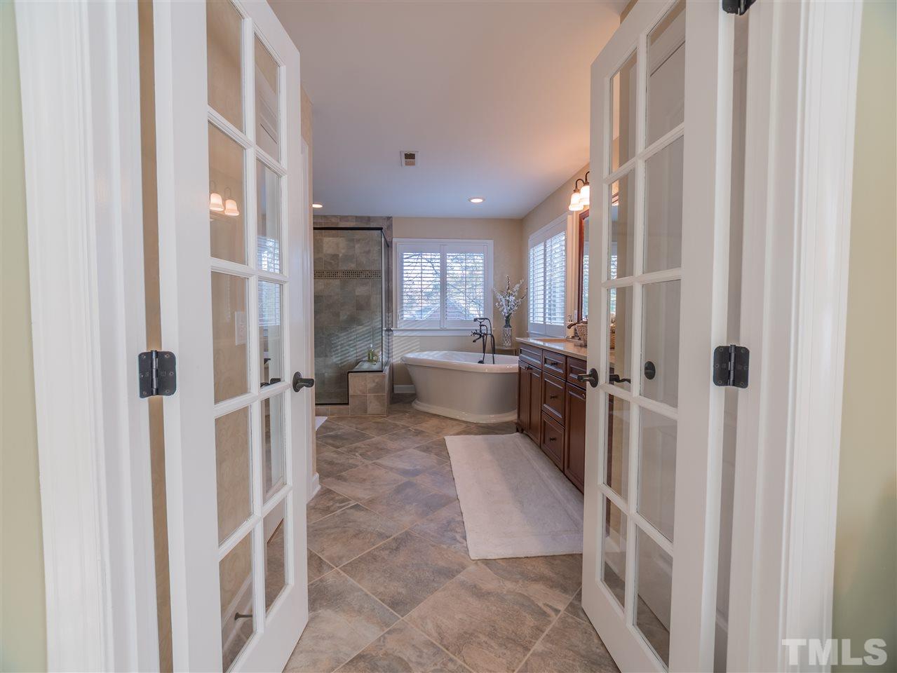 4016 White Chapel Way Raleigh, NC 27615 - Photo 16 of 30 The sumptuous master bath features heated tile flooring, comfort height dual vanity with quartz tops and u/m porcelain sinks, ORB fixtures, a large walk-in shower and a beautiful stand alone tub. There is also a separate water closet.