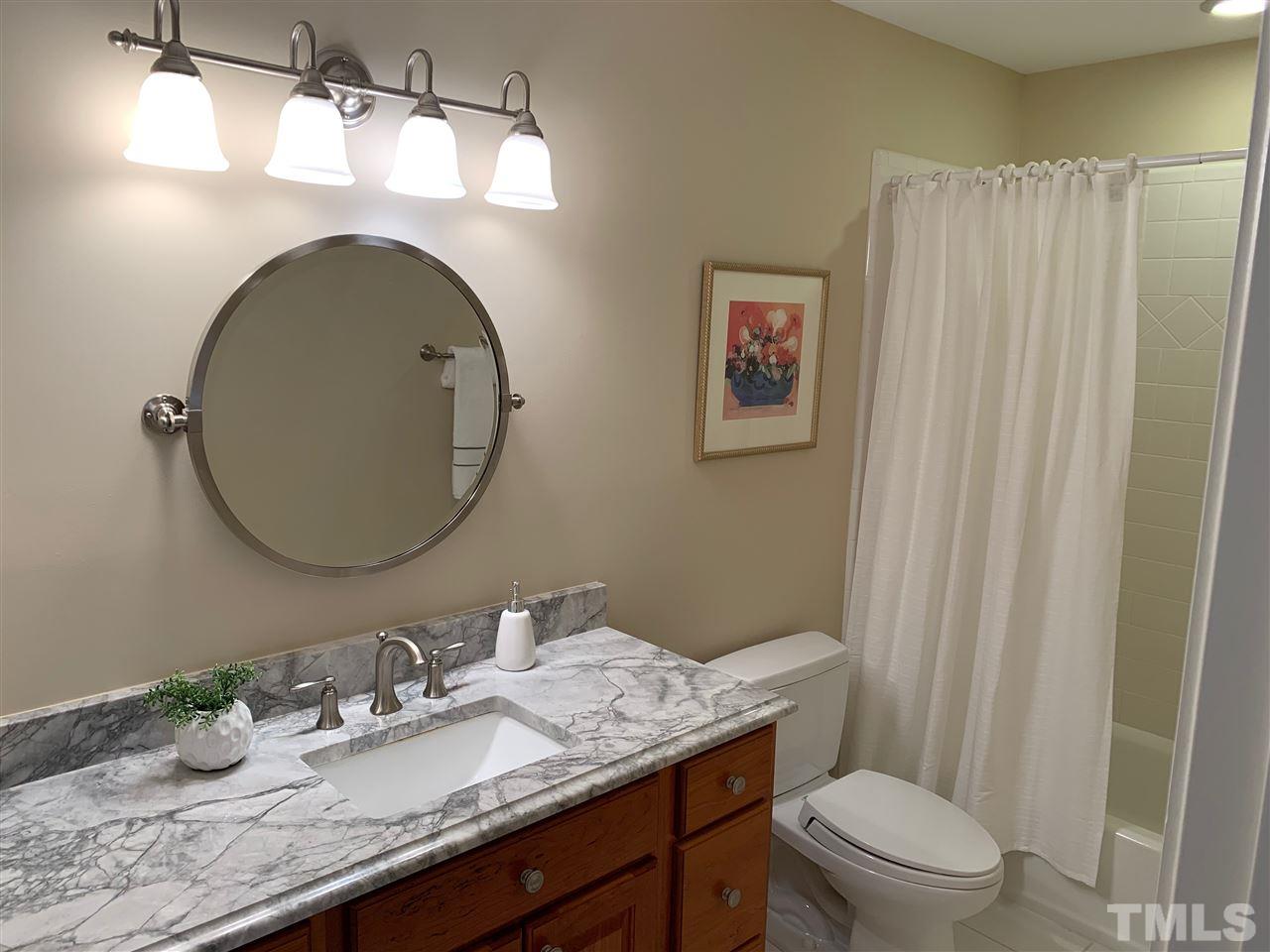 4016 White Chapel Way Raleigh, NC 27615 - Photo 22 of 30 Beautifully updated with comfort height cabinet, marble top with u/m sink, brushed nickel fixtures and Toto commode